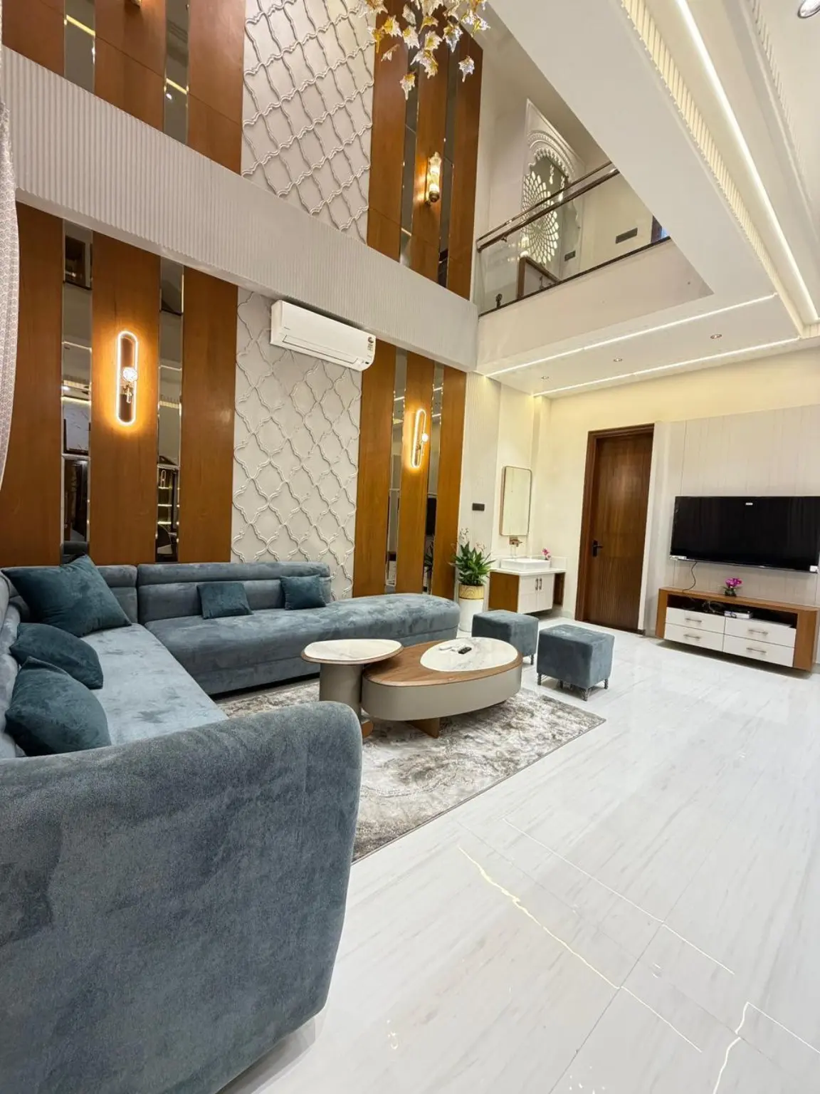 Double-height furnished living room in the four-bedroom villa